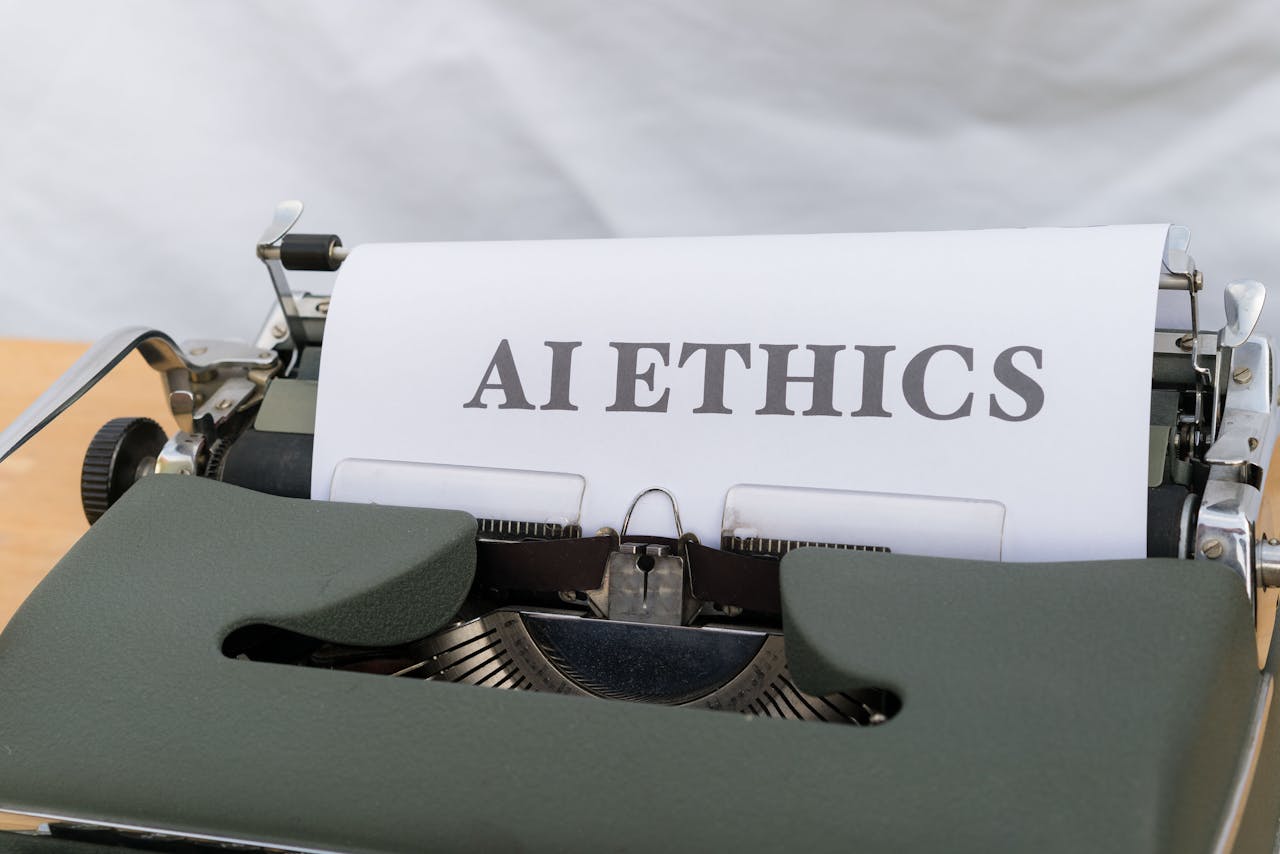 Close-up of vintage typewriter with 'AI ETHICS' typed on paper, emphasizing technology and responsibility.